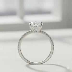 Side view of a 2 carat oval engagement ring with a delicate micropavé diamond band.