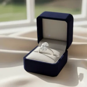 Elegant oval diamond engagement ring presented in a luxurious velvet ring box.