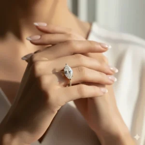 A captivating shot of a hand wearing a stunning yellow gold marquise engagement ring, emphasizing its flattering, finger-lengthening effect.