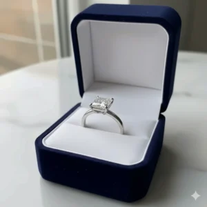 A luxurious velvet ring box holding a magnificent 2 carat princess cut diamond ring.