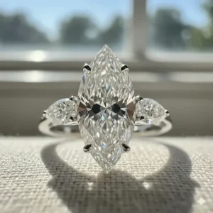 Illustration focusing on the brilliance of the center marquise cut diamond in a three stone setting.