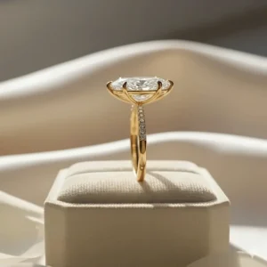 Side view of a yellow gold marquise engagement ring highlighting the secure V-tip and basket setting that protects the diamond.