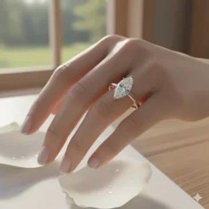 Stunning solitaire marquise engagement ring worn on a finger to illustrate how the unique cut elongates the hand.