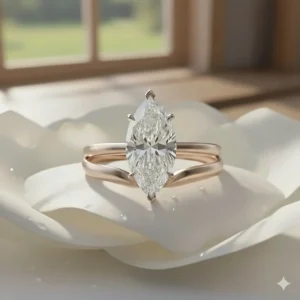 Elegant pairing of the solitaire marquise engagement ring with a perfectly curved, plain gold wedding band.