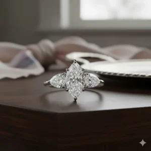 A stunning marquise diamond three-stone ring flanked by two accent pear-shaped diamonds.