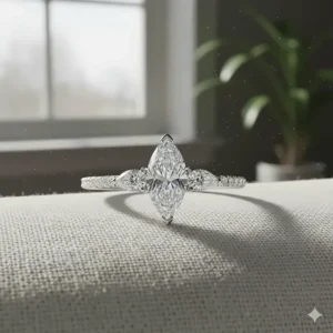 Platinum three stone marquise engagement ring featuring a delicate pavé diamond band.