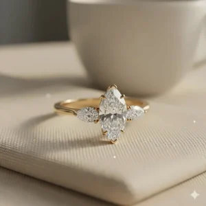 Classic three stone marquise engagement ring set in warm 14k yellow gold.