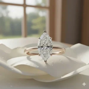 Beautiful rose gold solitaire marquise engagement ring with a delicate band and a brilliant, eye-catching diamond.