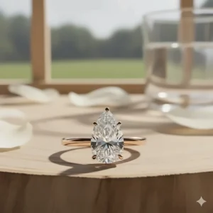 A romantic rose gold pear shaped engagement ring set with a modern diamond, perfect for a vintage or feminine look.