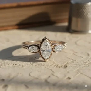 Vintage-inspired three stone marquise engagement ring with milgrain detailing.