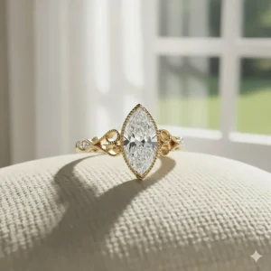 Detailed image of a vintage-inspired yellow gold marquise engagement ring with intricate filigree work and milgrain detailing.