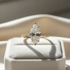 Beautiful yellow gold marquise engagement ring with a delicate pavé diamond band for extra sparkle and brilliance.