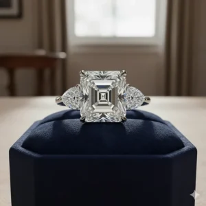 Luxurious three-stone asscher cut engagement ring with two half-moon side stones for extra brilliance.