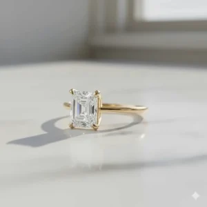 A beautiful Asscher cut wedding ring set in warm 18k yellow gold, showcasing a popular metal variation outside of standard white gold or platinum.