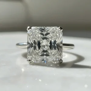 Extreme close-up of a high-clarity, large Asscher cut diamond in a wedding ring to emphasize the crystal-clear transparency of the stepped facets.