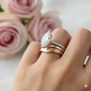 Beautiful marquise engagement ring paired with a complementary rose gold wedding band for a warm, modern look.
