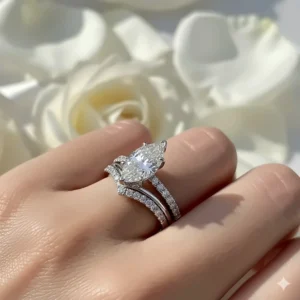 A complete bridal set, showing a marquise cut engagement ring perfectly paired with a custom contoured wedding band.