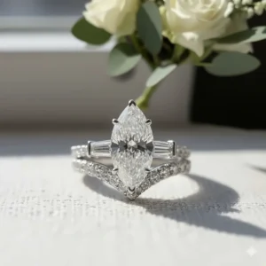 The perfectly nesting wedding band secured flush against the marquise engagement ring, demonstrating how the set sits together.