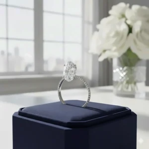 Elegant oval-cut solitaire engagement ring on a thin micropavé band, which makes the center stone appear larger.