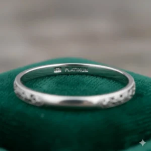 Image demonstrating how to inspect the inside of an Art Deco engagement ring for jeweler hallmarks or stamps that help verify its age and authenticity.