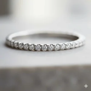 Close-up detail of a delicate thin wedding band featuring a micro-pave diamond setting for a subtle sparkle.