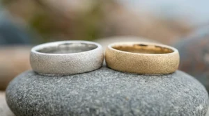Two matching sandblast texture rings in sterling silver and 14k yellow gold.
