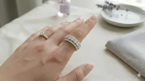 A 6mm wide diamond band stacked with a classic solitaire engagement ring for a bridal set look.