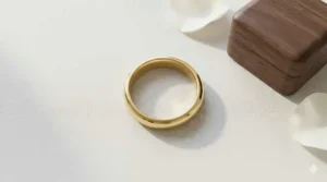 Top-down view of a 14k simple plain gold band highlighting its uniform width and smooth texture.