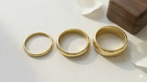 A comparison of three simple plain gold bands in different widths ranging from thin to wide.