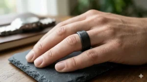 Men's matte black tungsten wedding band with a laser-engraved geometric pattern.