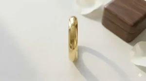 Side profile of a simple plain gold band showing the thickness and rounded dome edges.