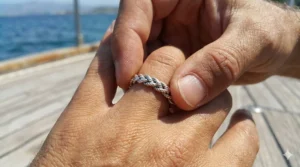 Polished sterling silver nautical rope ring design with a continuous twist texture.