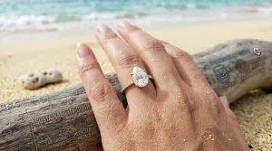 A unique pear shaped lab grown diamond engagement ring in a rose gold pave setting