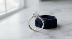 Modern white gold oval engagement ring featuring a sparkling hidden halo of pavé diamonds.