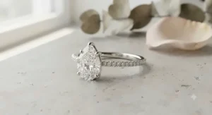 Stunning pear-shaped diamond engagement ring with a dainty white gold band.