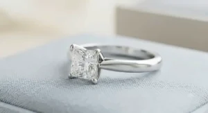 Classic solitaire white gold princess cut engagement ring highlighting a square diamond on a sleek band.