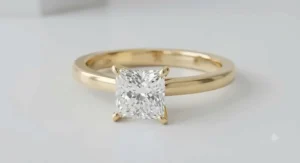 Classic solitaire yellow gold princess cut ring showcasing a clean band