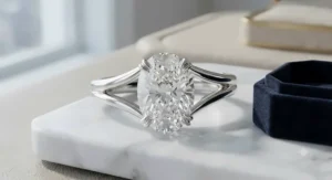 Sophisticated split-shank white gold oval engagement ring with a secure double-prong setting.