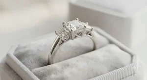Elegant three stone white gold princess cut engagement ring symbolizing past, present, and future.