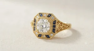 Art deco style yellow gold cushion cut ring with intricate filigree details