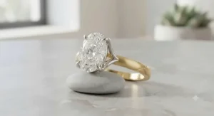 Custom two-tone oval engagement ring displaying a high-set center diamond and contrasting metal finish.