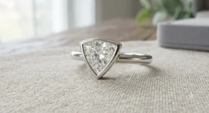 Modern bezel-set trillion cut engagement ring with a sleek, low-profile design ideal for active lifestyles.