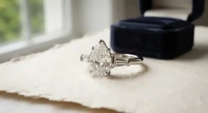A pear-shaped engagement ring accented with tapered baguette side stones, creating a sophisticated three-stone look.