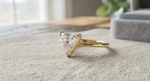 Stunning trillion cut diamond engagement ring set in 14k yellow gold for a timeless, warm aesthetic.