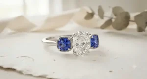 A unique three-stone engagement ring featuring a sparkling center diamond paired with vibrant blue sapphire side stones.