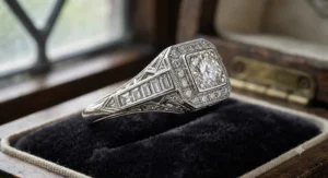 A vintage-inspired Art Deco engagement ring showcasing intricate milgrain detailing and channel-set baguette diamonds.