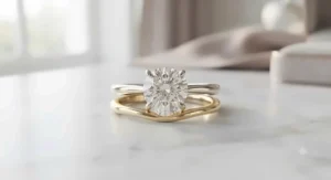 A warm 14k yellow gold engagement ring and wedding band set displaying a classic oval-cut solitaire paired with a smooth contoured wedding band.