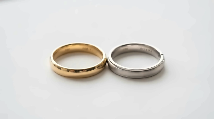 A side-by-side comparison of a rose gold ring and a yellow gold ring on a neutral surface, rose gold vs yellow gold ring