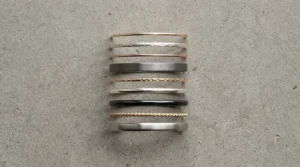 A visual comparison of band widths featuring stackable wedding bands for petite fingers.